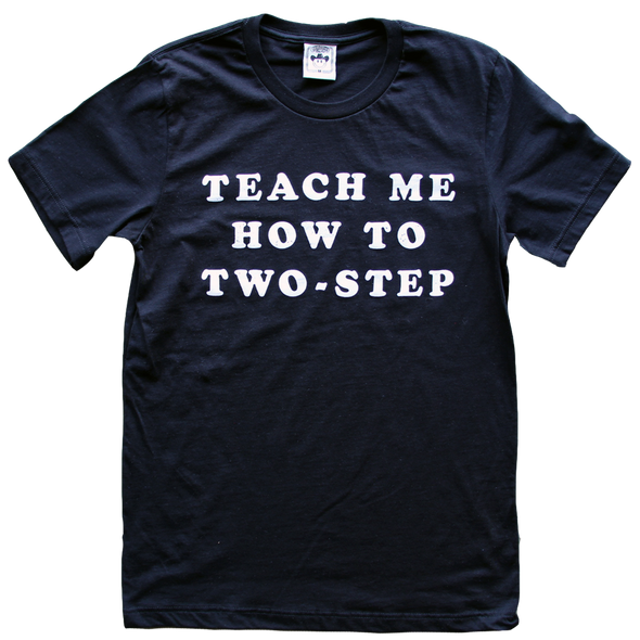 "Teach Me How To Two-Step" by Vinyl Ranch is a vintage-inspired design printed in white on a classic black tee.