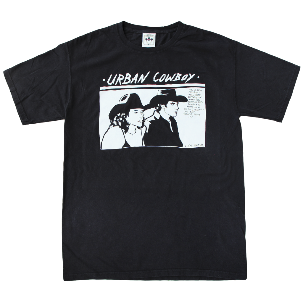 "Urban Cowboy" is a design inspired by the classic film, printed in white ink on a classic black tee by Vinyl Ranch. "You a real cowboy?"